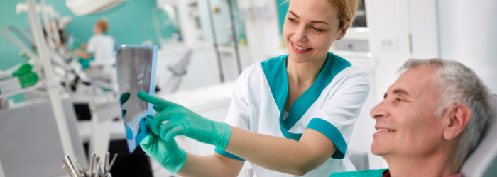 dentist showing patient xrays