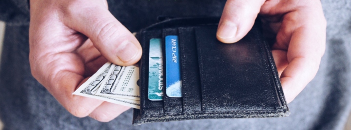 hand pulling money out of wallet