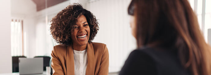 2 women in office talking