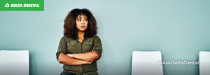 concerned looking woman sitting in waiting room of dentist