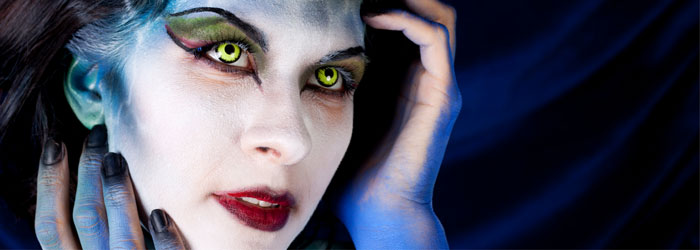 woman with face painted wearing colored contacts