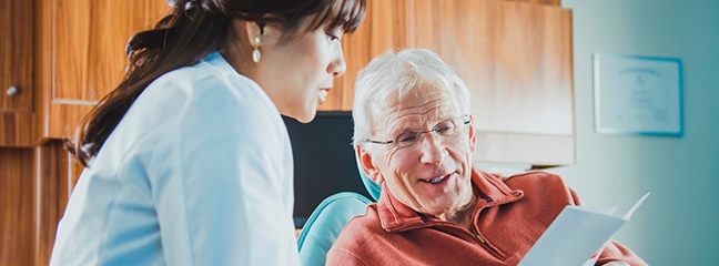 Man going over dental information with dentist