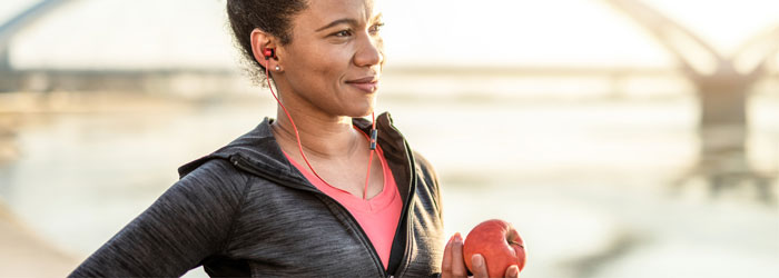 woman running with apple in hand