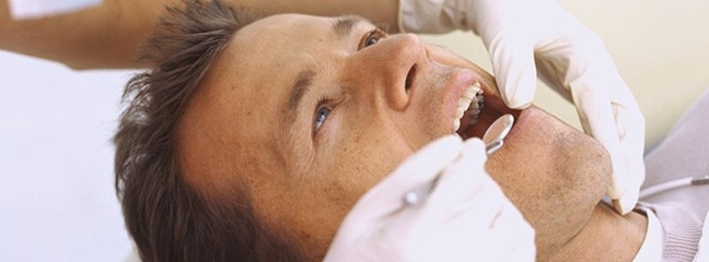 Man getting an exam at the dentist