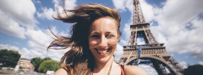 Smiling girl in front of Eiffel Tower