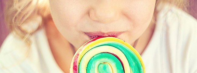 girl eating a lollipop