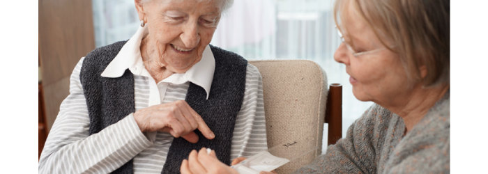 elderly woman holding medication