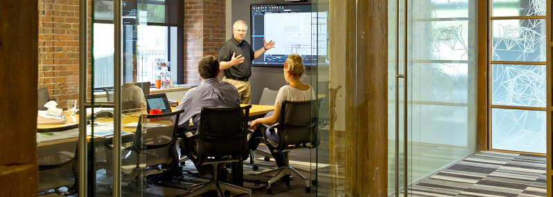 people sitting and working in conference room