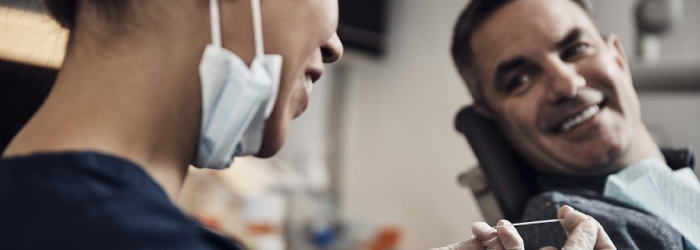 man sitting in dentist chair