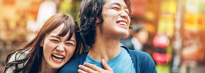 man and woman laughing together