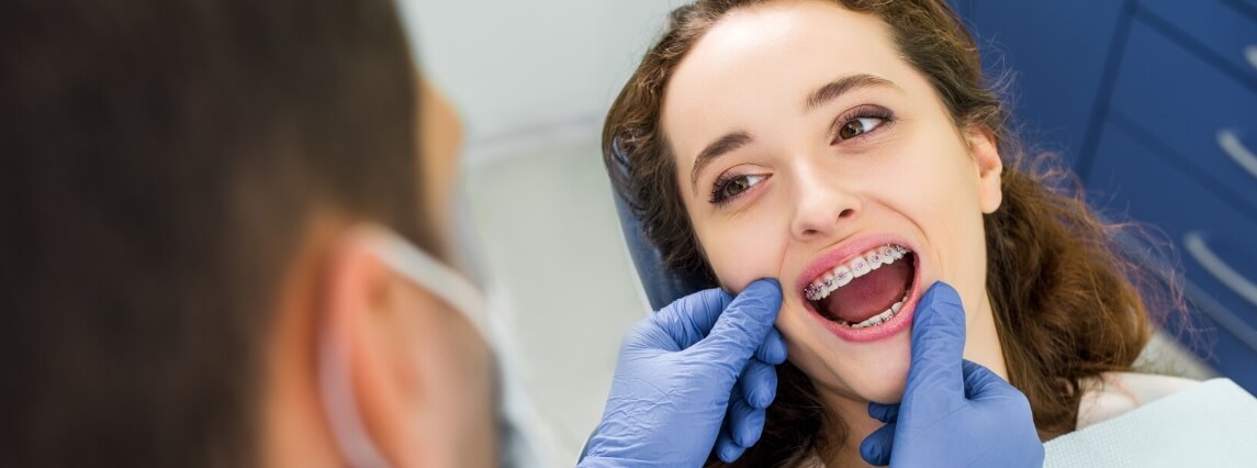 girl at the dentist getting fitted for braces