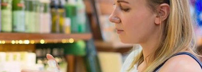 woman checking expiration date on toothpaste