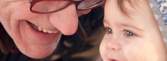 older man with smiling child