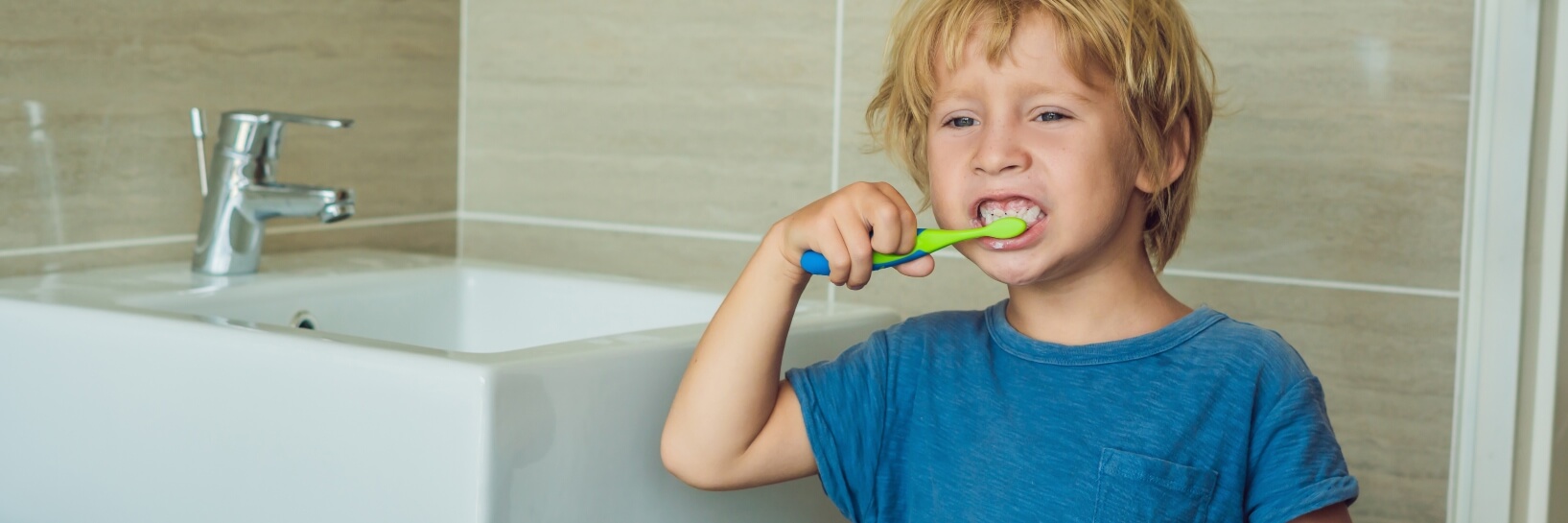 boy brushing his teeth 