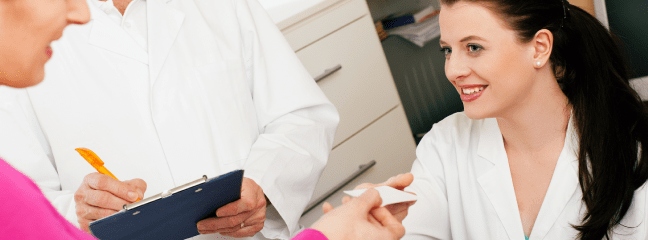 woman handing a card to another woman