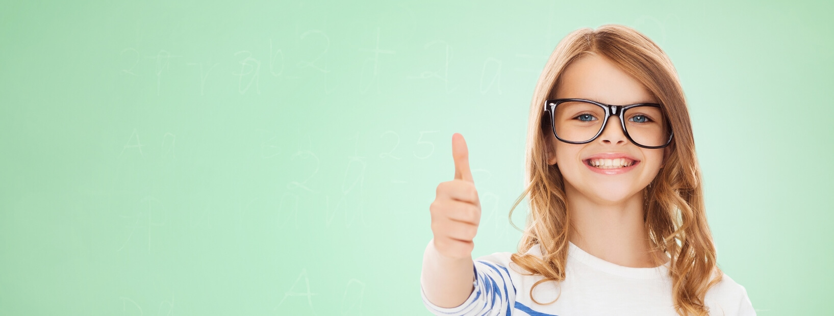 little girl with glasses giving a thumbs up
