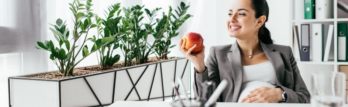 pregnant woman eating an apple 