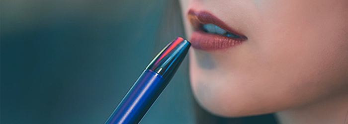 woman holding vape pen to her mouth
