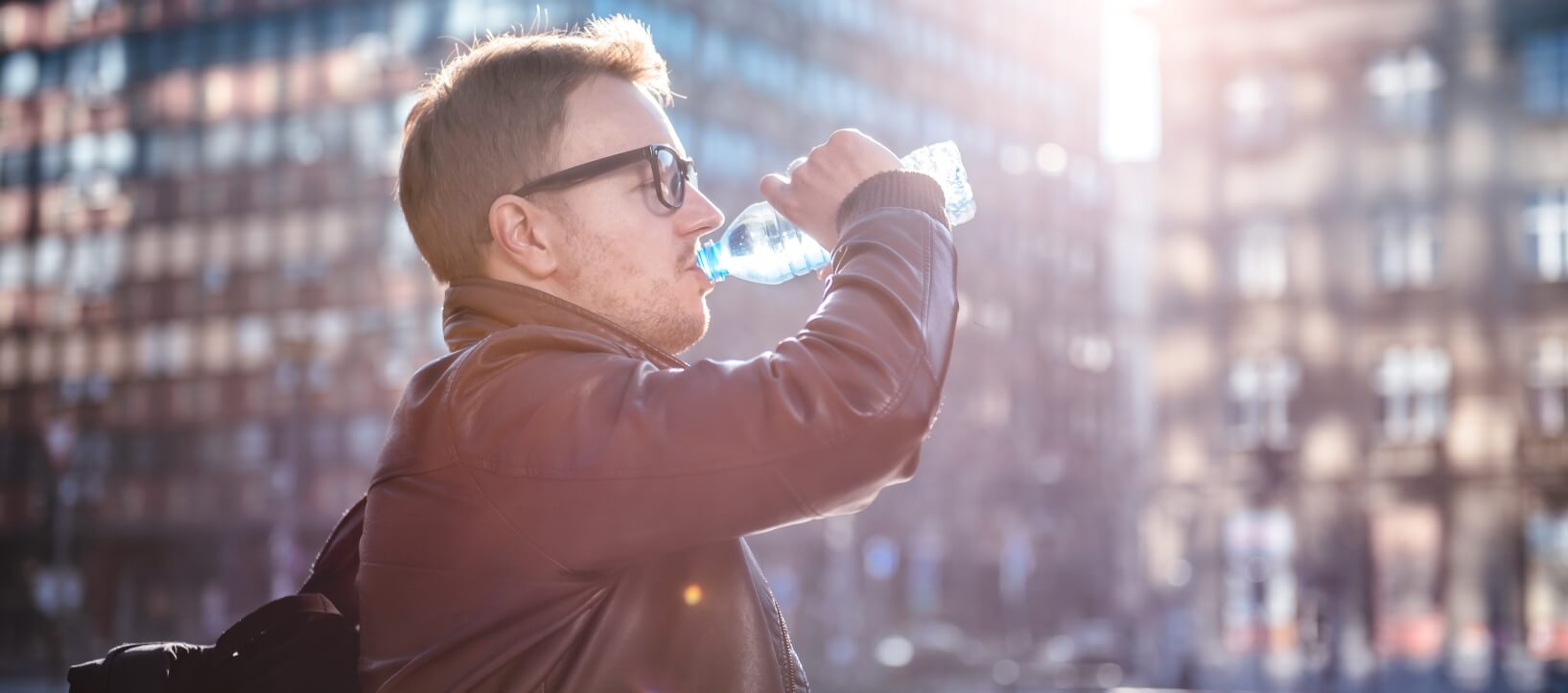 small smiling children lined up in front of a colorful wall