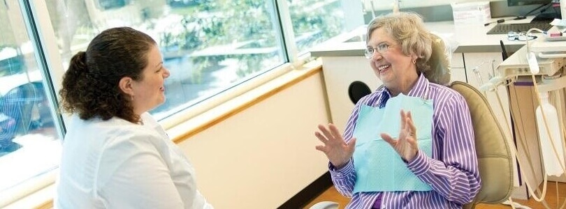 woman speaking with dentist