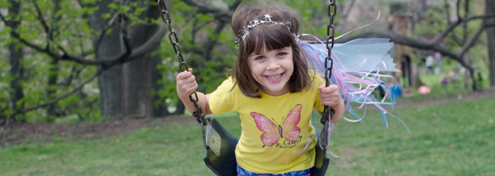 girl smiling while swinging