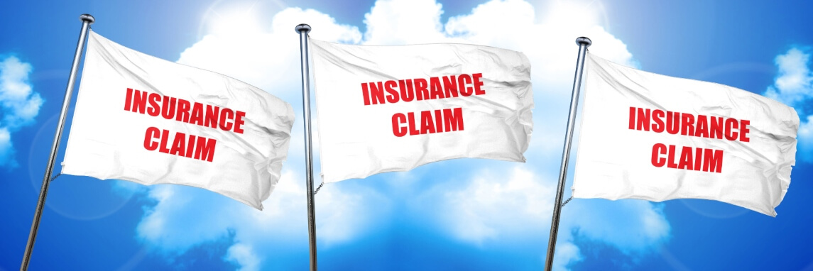 3 insurance claim flags against a blue sky