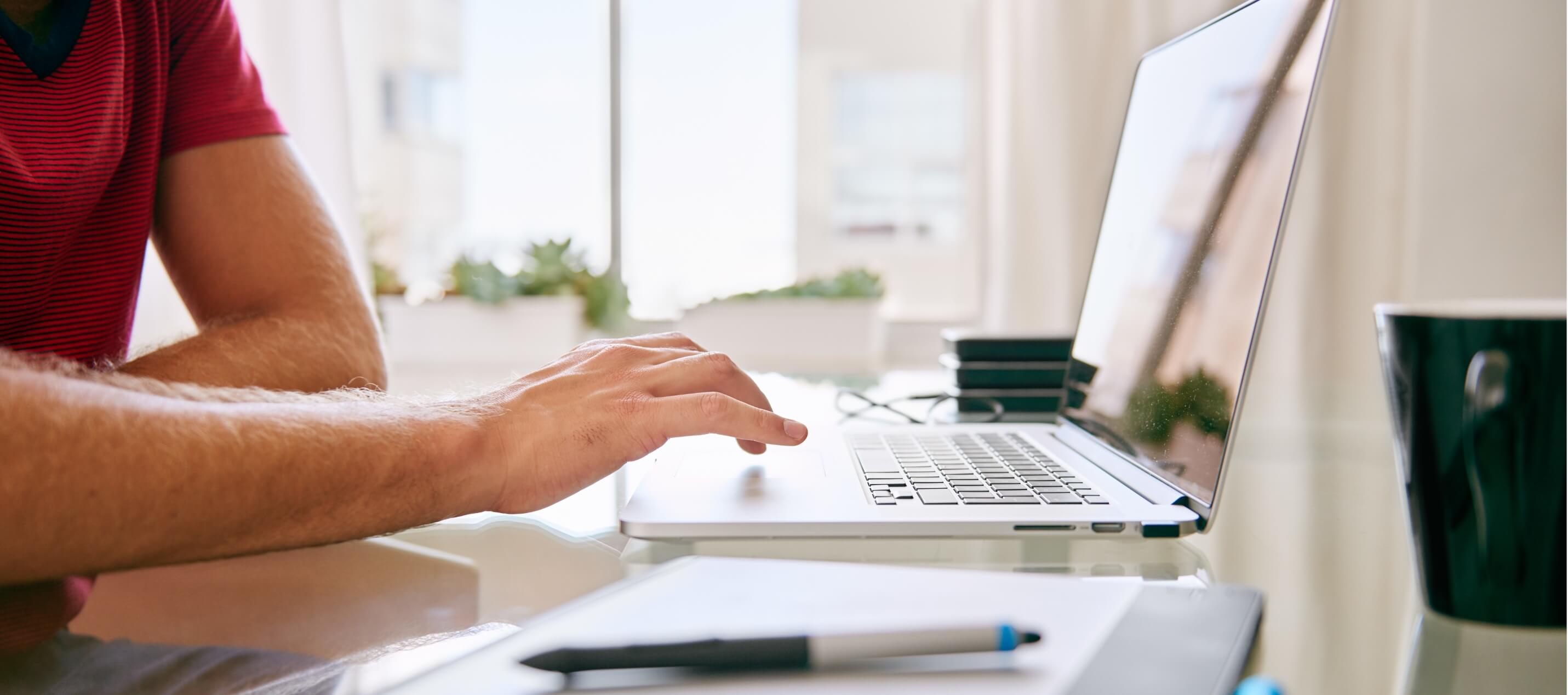 man browsing forms on laptop