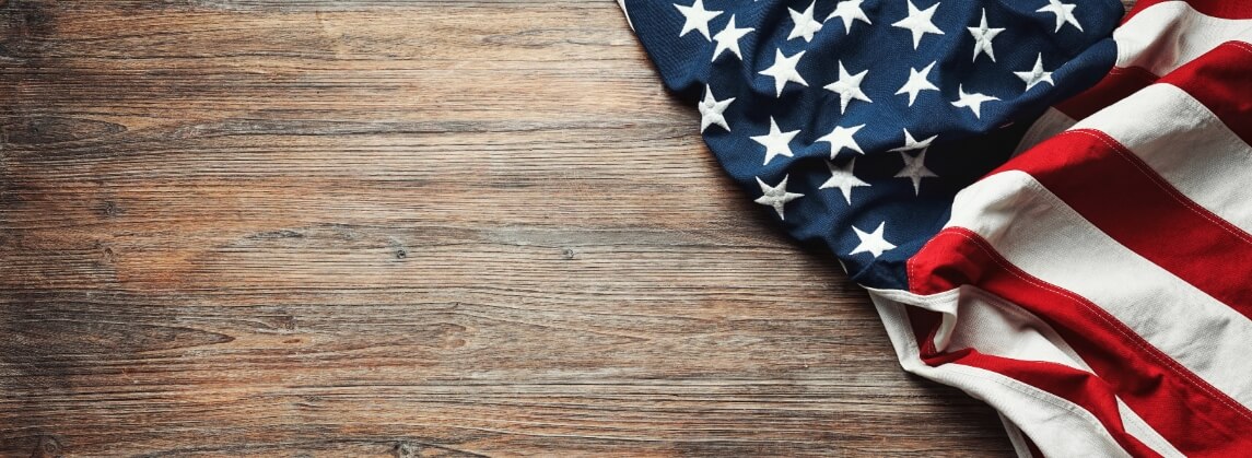american flag laying on wood background